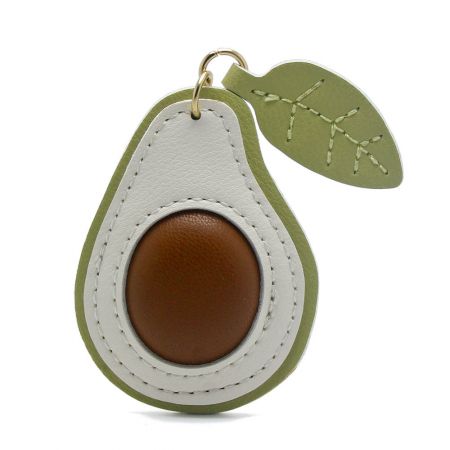 Side view of the stylish avocado fruit keychain made of PU leather, highlighting the detailed stitching.