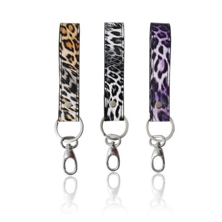 Three stylish leopard print wristlet keychains with gold-tone hardware.