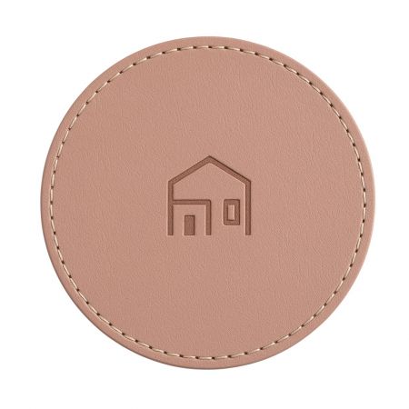 Light pink leather coaster with a simple house logo.