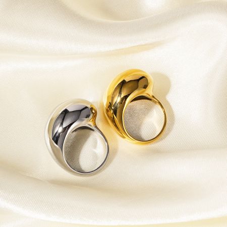 Detailed view of the drop-dripping design on both the gold and silver rings.