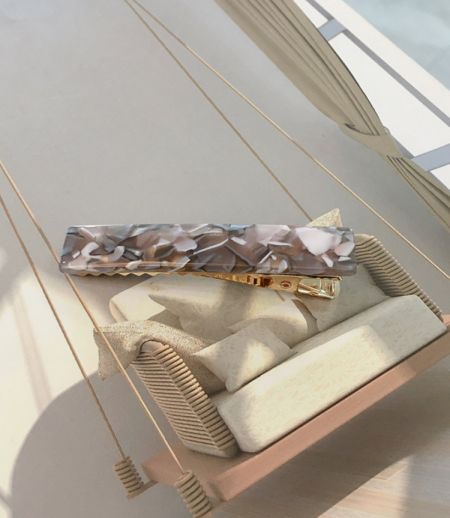Close-up of a stylish marbled acetate resin hair clip.