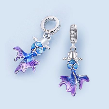 Close-up van een 925 sterling zilveren zeemeerminstaart bedel met blauwe en paarse emaille, weergegeven als een oorbel.