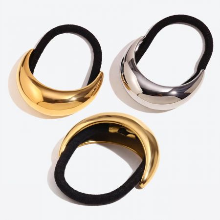 A collection of three metallic hair ties, two in silver and one in gold, showing their simple design.
