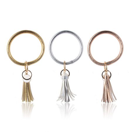 Stylish metallic tassel keychains in gold, silver, and rose gold finishes.