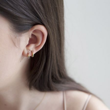 Model wearing the CZ Pave Rainbow Colour Hoops in her ear lobe.