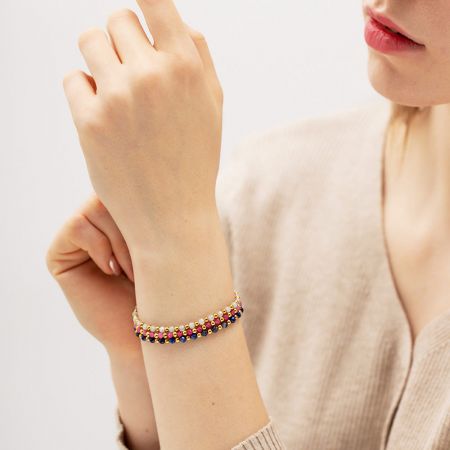 Clean product shot of a multicolored stainless steel and glass bead bracelet on a white background.