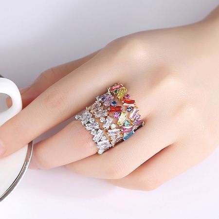 A model wearing the ZigZag Rainbow Baguette Ring, showing how it can be stacked.