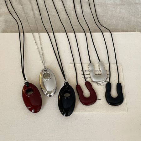Brass Necklace Collection - A diverse collection of brass necklaces from JR Fashion Accessories, featuring various pendant designs and styles.