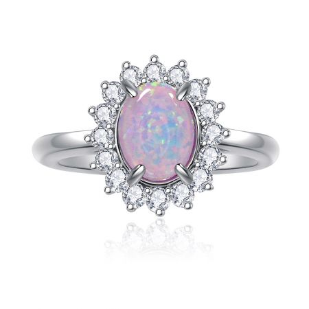 Pink Opal Burst White Ring - A close-up of the Pink Opal Burst White Ring, showcasing the central pink opal glass stone surrounded by a halo of sparkling white cubic zirconia on a rhodium-plated brass band.