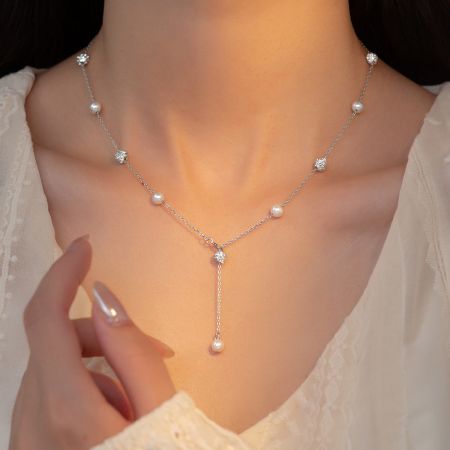 Detailed product view of the silver pearl and CZ necklace.