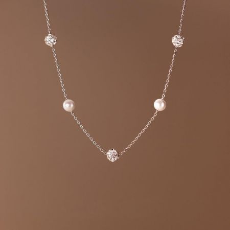 Close-up of the Y-drop tassel design with pearls and gemstones.