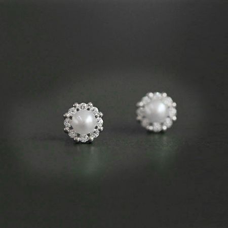 A classic and elegant pair of pearl earrings with a sparkling gemstone halo.