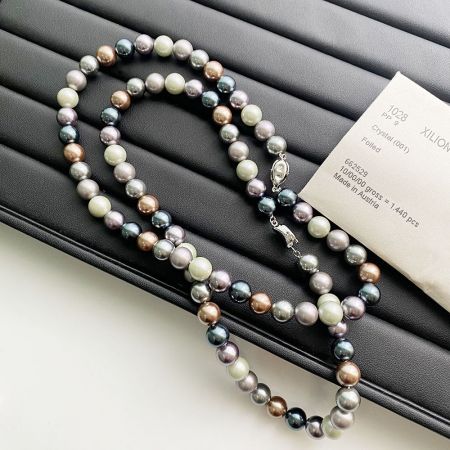 A set of Morandi color pearl necklaces and a matching bracelet displayed for sale.