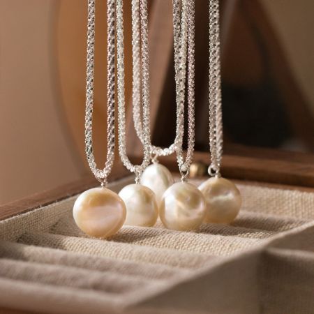 Multiple 925 silver baroque pearl necklaces displayed together, highlighting the unique pearls and silver chains.