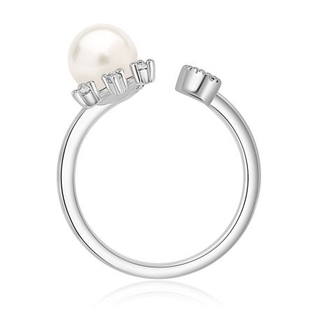 Close-up product shot of the pearl sun ring on a reflective surface, highlighting its shine and craftsmanship.
