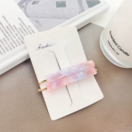 A beautiful pink and purple marbled acetate hair clip, perfect for adding a pop of color.