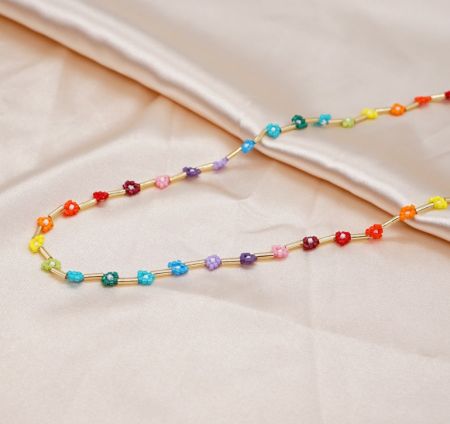 A vibrant rainbow-themed beaded necklace with a gold chain, perfect for summer wear.