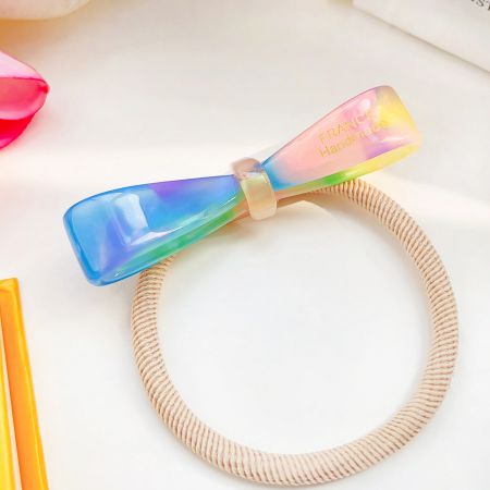 Plastic Acetic Acid Acetate Bowknot Hair Ponytail Bands - A colorful rainbow-patterned acetate bowknot hair tie, part of a set of handmade ponytail bands.