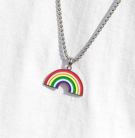 Detailed view of a circular rainbow pendant necklace, highlighting the vibrant enamel colors and stainless steel finish.