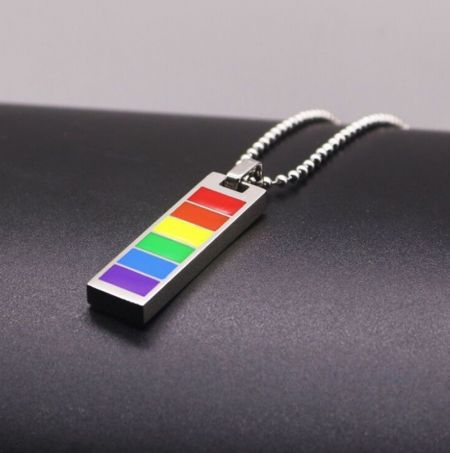 Detailed view of the rainbow pride pendant necklace, highlighting the silver plating and lobster clasp.