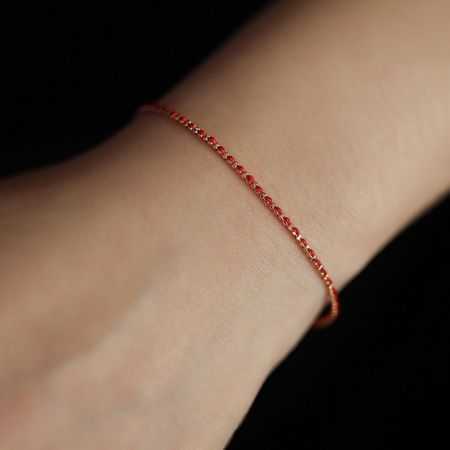 A model wearing the stylish red 925 sterling silver braided bracelet.