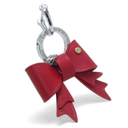 Portachiavi a fiocco in PU rosso vivace con chiusura sicura e centro in strass.