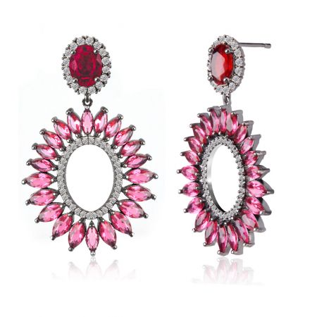 Close-up van de Red Radiant CZ Oorbellen met het zonnestraalontwerp en rode en roze edelstenen.