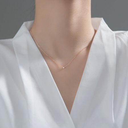 Model wearing the elegant rose gold CZ stone necklace, showcasing its length and style.