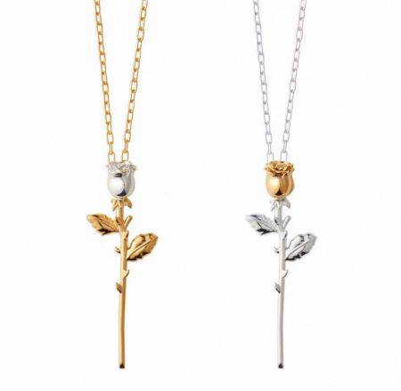 Two variations of the rose-shaped necklace, one in gold and one in silver.