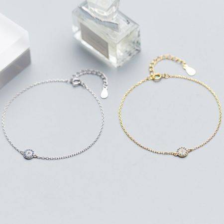 Elegant product shot of the silver and gold evil eye bracelets.