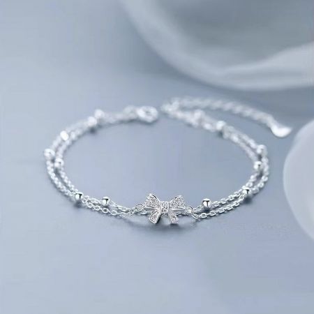 Product photo of the elegant silver bow bracelet, highlighting its polished finish.