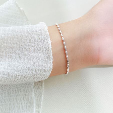 Close-up of the 925 sterling silver rice beaded bracelet worn on a wrist, showcasing its delicate design.
