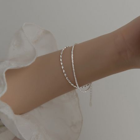 Model wearing the layered 925 sterling silver crystal bead chain bracelets to showcase the fit and style.