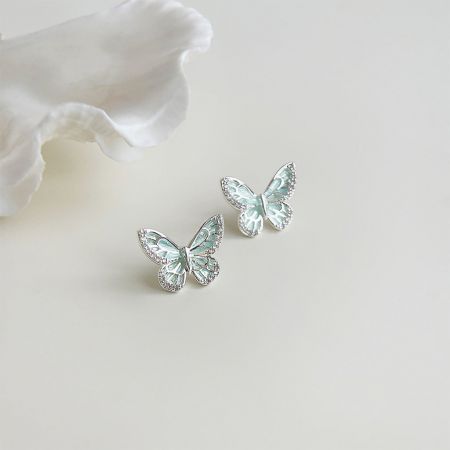 Detailed close-up of the silver-plated butterfly earrings showing the intricate enamel work.