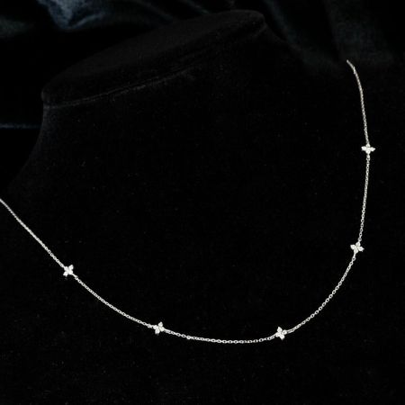Primer plano de un collar de encanto de mariposa de plata con circonitas cúbicas del conjunto de cinco piezas.