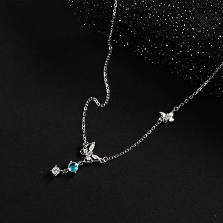 A sterling silver necklace featuring multiple butterfly pendants and shimmering gemstones.