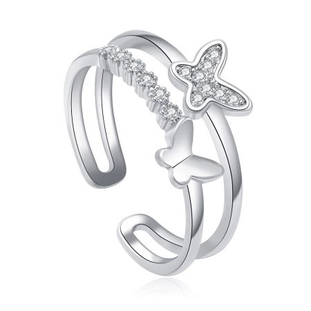 A detailed view of the double butterfly ring, showing the polished rhodium finish and the sparkle of the set stones.