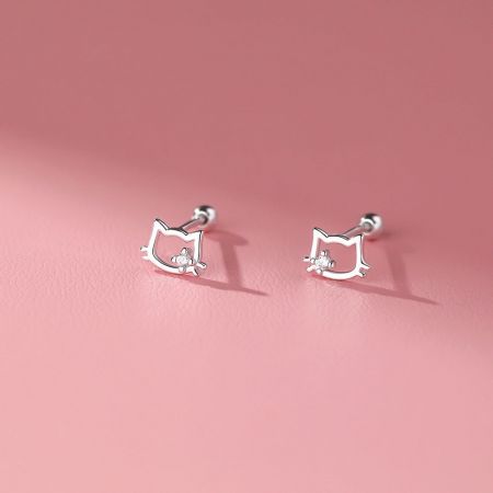 Pendientes de botón en forma de orejas de gato de plata esterlina con zirconia cúbica - Una vista en primer plano de los pendientes de botón en forma de orejas de gato de plata esterlina, cada uno con una piedra de zirconia cúbica brillante en el centro, exhibidos sobre una superficie texturizada.