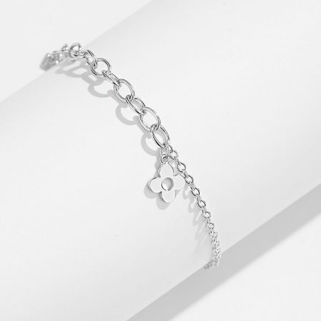 An elegant silver chain bracelet with a delicate flower charm.