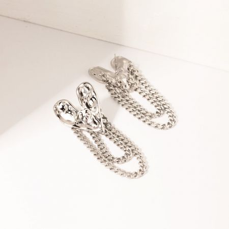 Intricately interwoven silver chain earrings, showcasing detailed craftsmanship.