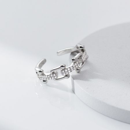 Detailed view of a sterling silver U-link ring from the set, adorned with clear CZ stones.
