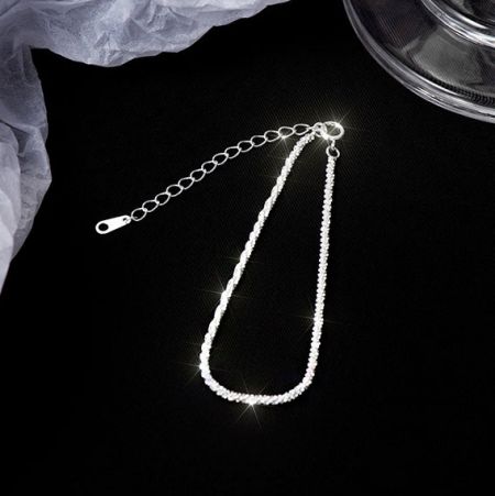 Toma de cerca de los eslabones de la cadena de plata del brazalete.