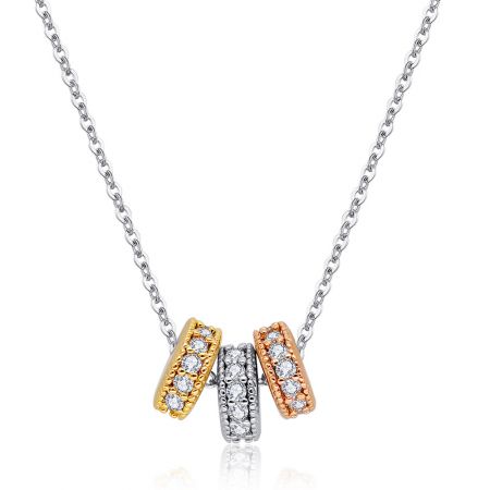 Detailed view of the cubic zirconia stones on the three-tone pendant.