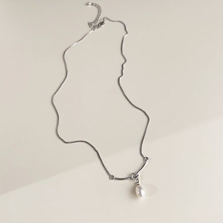 Front view of the silver chain necklace featuring a classic white pearl pendant.