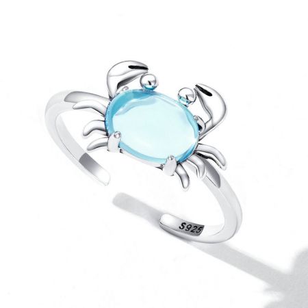 Side view of the sterling silver crab ring showcasing the light blue gemstone and intricate details.