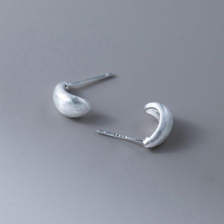 Another angle of the silver frosted curl stud earring, showing the post-back design.