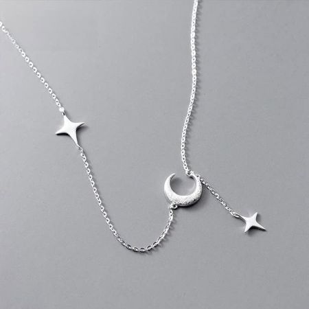 A clear view of the 925 silver necklace with its crescent moon and star design.