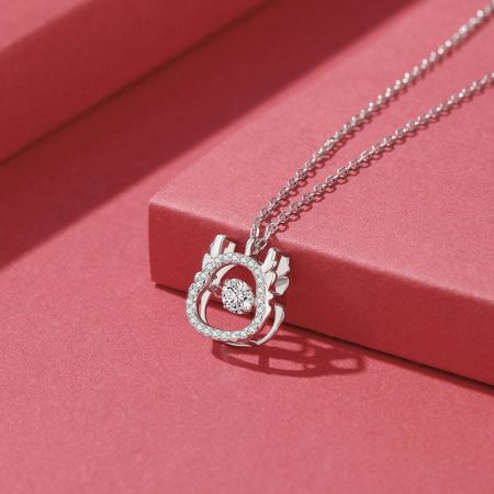 Side profile of the silver dragon pendant, emphasizing the spinning circular CZ stone feature.