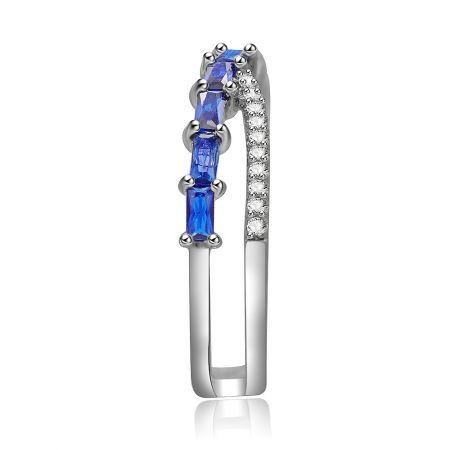Detailed close-up of the Cross Baguette-cut Blue Sapphire Ring, showing the intricate setting of the blue and white gemstones.