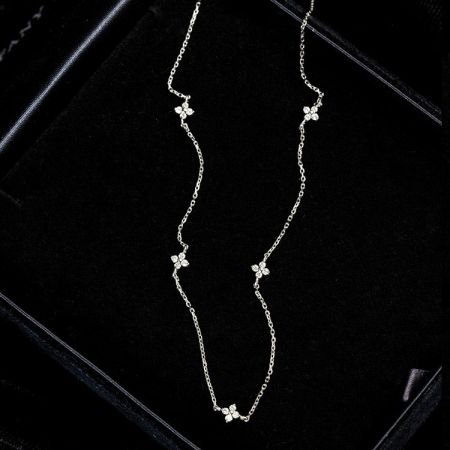 Close-up of a 925 silver chain with an intricate floral charm.